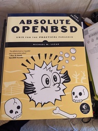 Absolute OpenBSD 2nd Edition book cover. Featuring a blowfish and some skulls and bones littered around an underwater scene