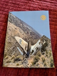 Cover of the 9front Dash1 manual, COMMUNITY VS INFRASTRUCTURE. Features a photograph of a mountainside with the wreckage of a plane embedded in it. The wreckage has the Python logo on one of the wings. The 9front logo is pictured in the sky