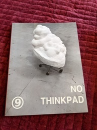 Cover of the 9front Dash 1 manual, NO THINKPAD edition. Features a sculpture that resembles a pile of whipped cream perched on casters that appear to be from an office chair. The 9front logo is in the bottom-left corner 
