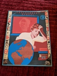 Cover of the 9front Programmer's Manual V4. Features a person intently reading a book while several more books are in a pile waiting to be read and a globe sits next to the reader. A red screen is behind the reader with the text 'up 2920 days' with the rest of the message obscured. The 9front logo is in the upper-right corner, and the indicator V4 is in the bottom-right.