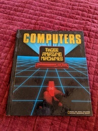 Cover of the book Computers Those Amazing Machines. Features a drawing of a computer overlaid on a blue and black grid that appears to stretch into the horizon. A hand is at the bottom holding a computer chip that is glowing red