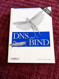 O'Reilly DNS and Bind fifth edition book cover. Features two grasshoppers, one jumping over the logo and one standing on it