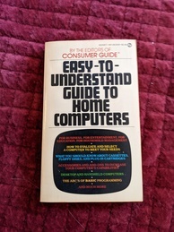 Easy-to-understand guide to home computers book cover. Mass market paperback with multi-colored text announcing the topics contained in the book