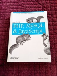 Learning PHP, MySQL, & JavaScript O'Reilly Media book cover. Features images of three flying squirrels crawling around the cover.