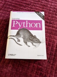 Learning Python O'Reilly Media book cover. Features an image of a wood rat.