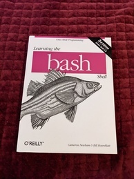 Learning the bash Shell O'Reilly Media book cover. Features an image of a silver bass.