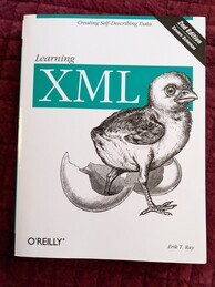 Learning XML O'Reilly Media book cover. Features an image of a chick and a broken eggshell