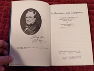Title page of Mathematics and Computers book. Featuring an image of Charles Babbage with a reproduced signature. The opposite page has the title, the authors listed, and a big stamp announcing 'WITHDRAWN'