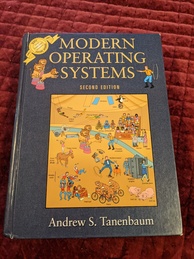 Cover of the Modern Operating systems book. Features an image of a circus with the performers acting as visual metaphors for various operating system concepts