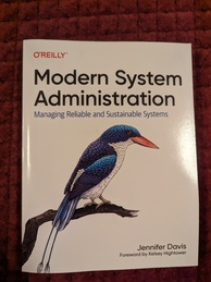 Modern System Administration book cover from O'Reilly. Featuring a color drawing of a paradise kingfisher