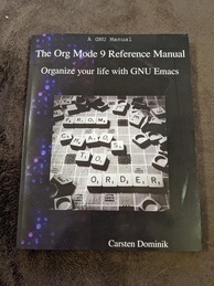 Cover of the Org 9 Reference manual. Has a picture of a Scrabble board with the words 'FROM CHAOS TO ORDER' spelled out and several other tiles haphazardly strewn about