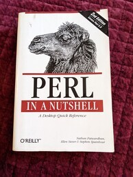 Perl in a Nutshell O'Reilly book cover. Features an image of the head of an Arabian camel perched on top of the logo.