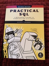 Practical SQL cover. Featuring a robot-like character filling the hopper of some kind of machine that is producing a box wrapped up with a bow on it