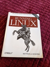 Running Linux O'Reilly Media book cover. Features an image of a cowboy riding a horse that is rearing up
