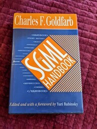 The SGML Handbook book cover. Blue and orange with a lot of SGML tags scattered around the orange logo