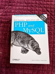 Cover of the Web Database Applications with PHP and MySQL O'Reilly book. Features an image of a platypus and a banner announcing the 2nd edition in the top-right corner