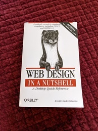 Cover of the Web Design in a Nutshell O'Reilly book, 3rd edition. Features an image of a least weasel popping up from behind the logo, its head, shoulders and forelimbs are visible. There is a banner announcing the 3rd edition in the upper-right hand corner