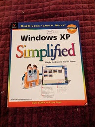 Windows XP Simplified 'Simply the Easiest Way to Learn' book cover. Featuring a floppy disk with arms and a face showing off a Windows XP desktop