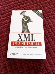 Cover of the XML in a Nutshell O'Reilly book, 3rd edition. Features an image of the head of a peacock and a banner announcing the third edition