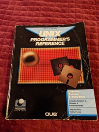 UNIX Programmer's Reference book cover. Features a grid of red squares with a border of yellow squares. Overlaid on top of the grid is an image of three 5.25'' floppy disks and a sphere 