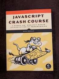 Javascript Crash Course book featuring a cat wearing goggles flying on a magic carpet being propelled by engines